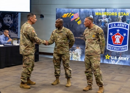 Command Sgt. Maj. Shade S. Munday, senior enlisted leader for U.S. Army Recruiting Command, presents a challenge coin to Command Sgt. Maj. Dwight K. Hart, 7th Brigade, U.S. Army Cadet Command, during the U.S. Army Recruiting Command Senior Leader Forum at the Patton Museum, Fort Knox, Kentucky, April 16, 2026.