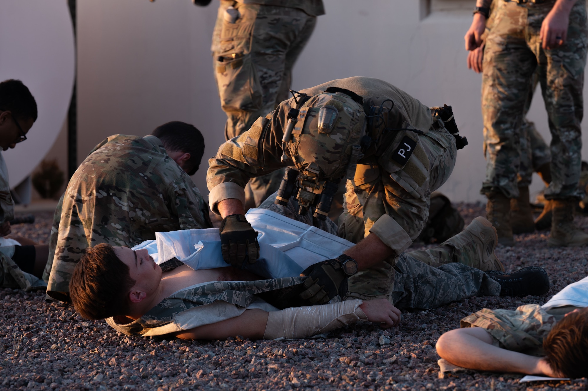 A U.S. Air Force Pararescueman assigned to the 68th Rescue Squadron assesses the wounds of a simulated casualty during the Combat Leader Course at Davis-Monthan Air Force Base, Arizona, April 17, 2026. During the scenario, Pararescuemen responded to a mass casualty event before providing tactical combat casualty care. (U.S. Air Force photo by Airman 1st Class Jaden Kidd)
