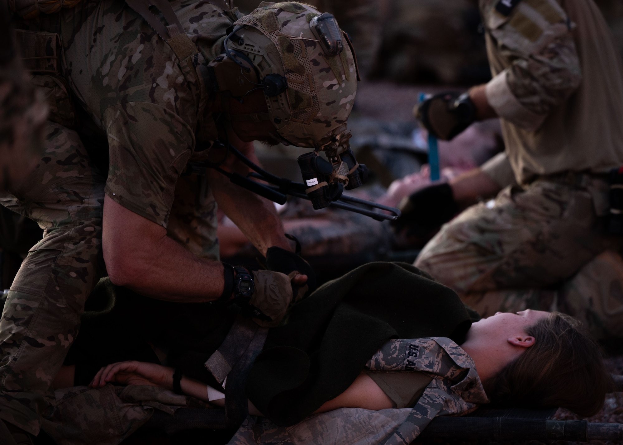 A U.S. Air Force Pararescueman assigned to the 68th Rescue Squadron provides medical care to a simulated casualty during the Combat Leader Course at Davis-Monthan Air Force Base, Arizona, April 17, 2026. CLC is designed to test the decision-making skills under duress to ensure mission success in austere environments. (U.S. Air Force photo by Airman Najzee Kuzu)