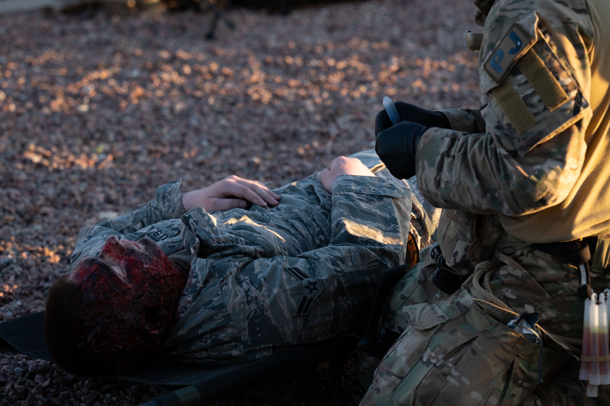 A U.S. Air Force Pararescueman assigned to the 68th Rescue Squadron provides medical care to a simulated casualty during the Combat Leader Course at Davis-Monthan Air Force Base, Arizona, April 17, 2026. CLC is an intensive training event that develops Pararescuemen’s advanced rescue tactics and leadership skills. (U.S. Air Force photo by Airman 1st Class Jaden Kidd)