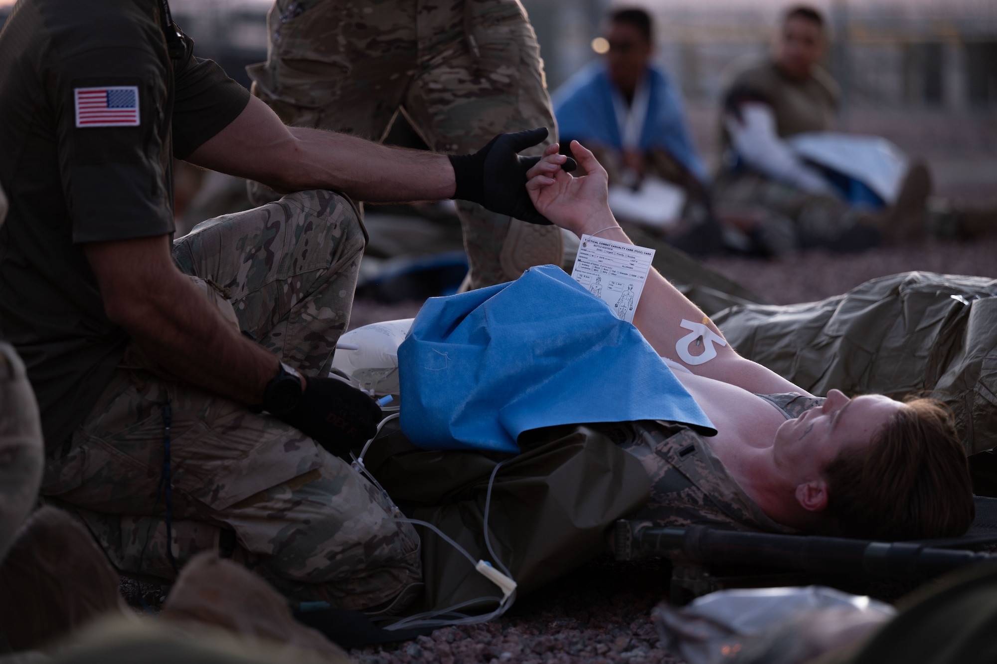A U.S. Air Force Pararescueman assigned to the 68th Rescue Squadron provides medical care to a simulated casualty during the Combat Leader Course at Davis-Monthan Air Force Base, Arizona, April 17, 2026. CLC places Pararescuemen in realistic, high-stress scenarios designed to strengthen decision-making during rescue missions. (U.S. Air Force photo by Airman 1st Class Jaden Kidd)