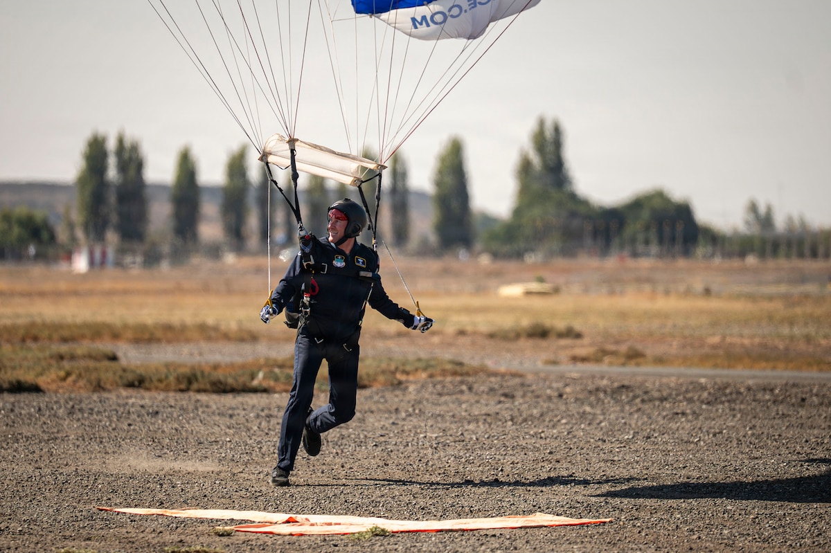 U.S. Air Force Lt. Col. Tripp Johnson, Wings of Blue commander, lands following a parachute demonstration during FIDAE in Santiago, Chile, April 11, 2026. The demonstration underscores the professionalism and precision of U.S. Air Force personnel while supporting international engagement through aerial demonstration and outreach. (U.S. Air Force photo by Airman 1st Class Samantha Melecio)