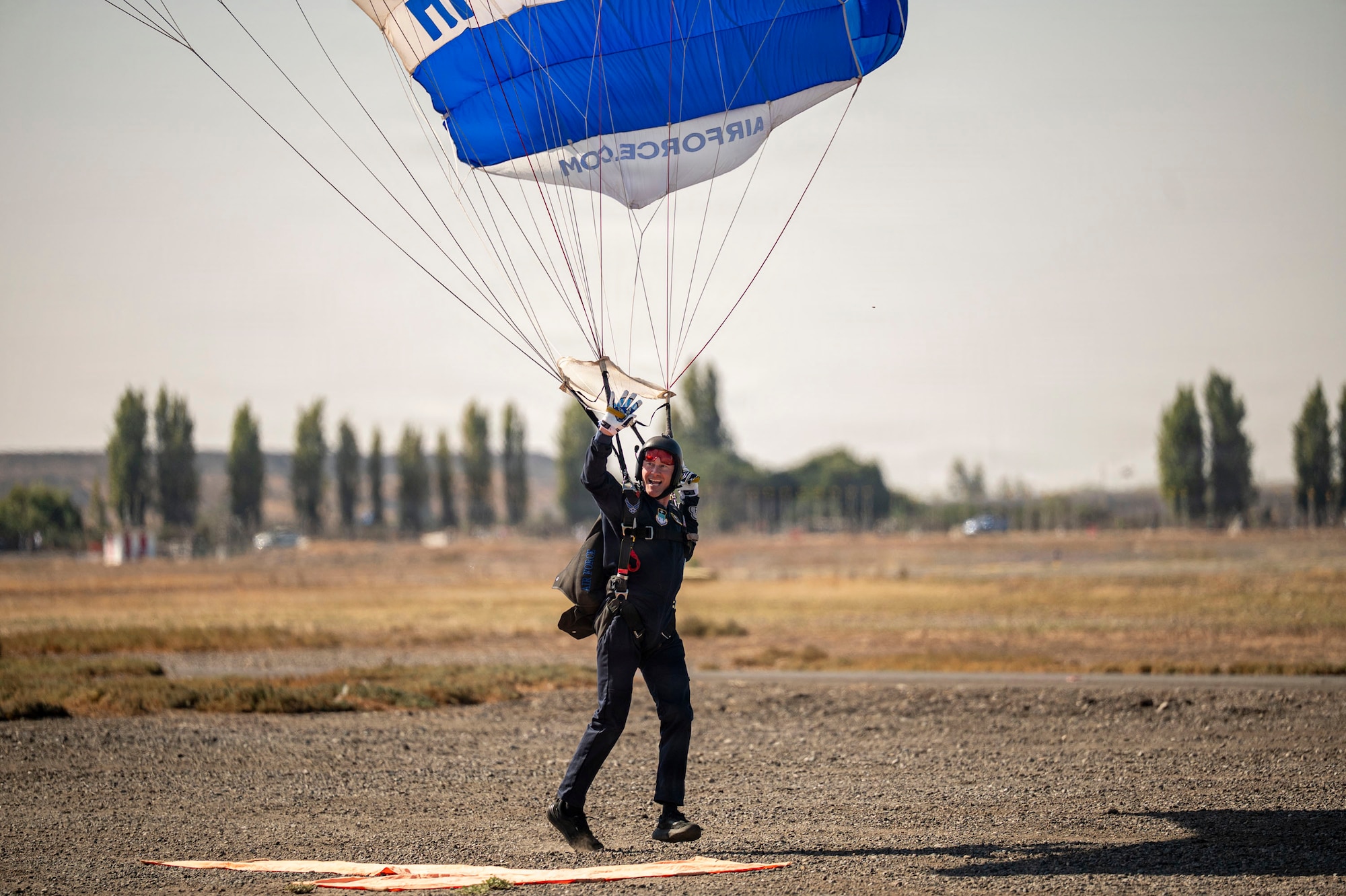 U.S. Air Force Lt. Col. Tripp Johnson, Wings of Blue commander, lands after a parachute demonstration during FIDAE in Santiago, Chile, April 11, 2026. U.S. presence at FIDAE reinforces long-standing defense cooperation with Chile, promoting collaboration in areas such as humanitarian assistance and disaster response. (U.S. Air Force photo by Airman 1st Class Samantha Melecio)