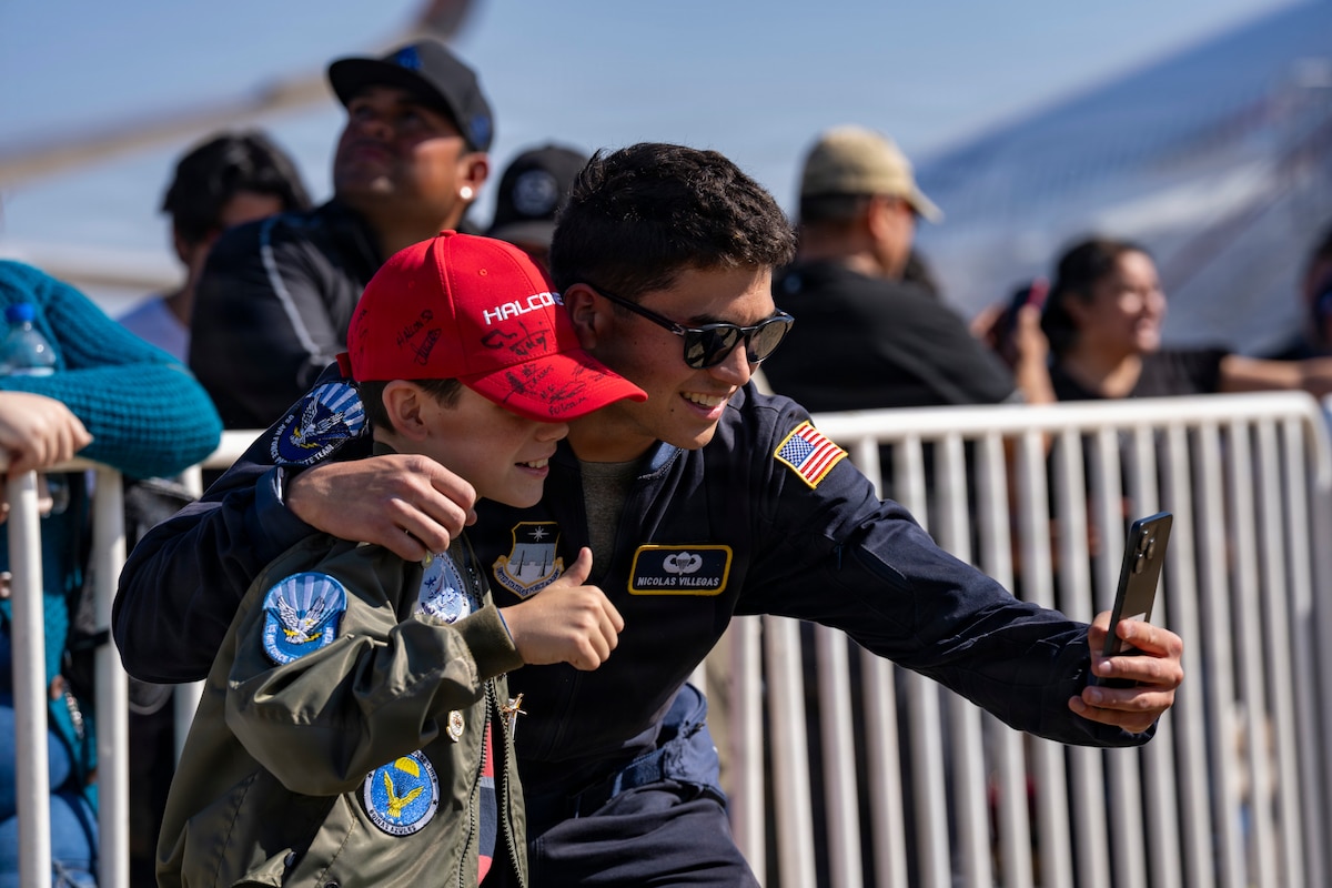 U.S. Air Force Academy Cadet Nicolas Villegas, Wings of Blue parachutist, takes a photo with a Chilean fan at Feria Internacional del Aire y del Espacio (FIDAE) 2026 in Santiago, Chile, April 11, 2026.U.S. participation in FIDAE 2026 highlighted the United States’ commitment to strengthening partnerships and promoting regional stability through air and space cooperation.(U.S. Air Force photo by Andrea Jenkins)