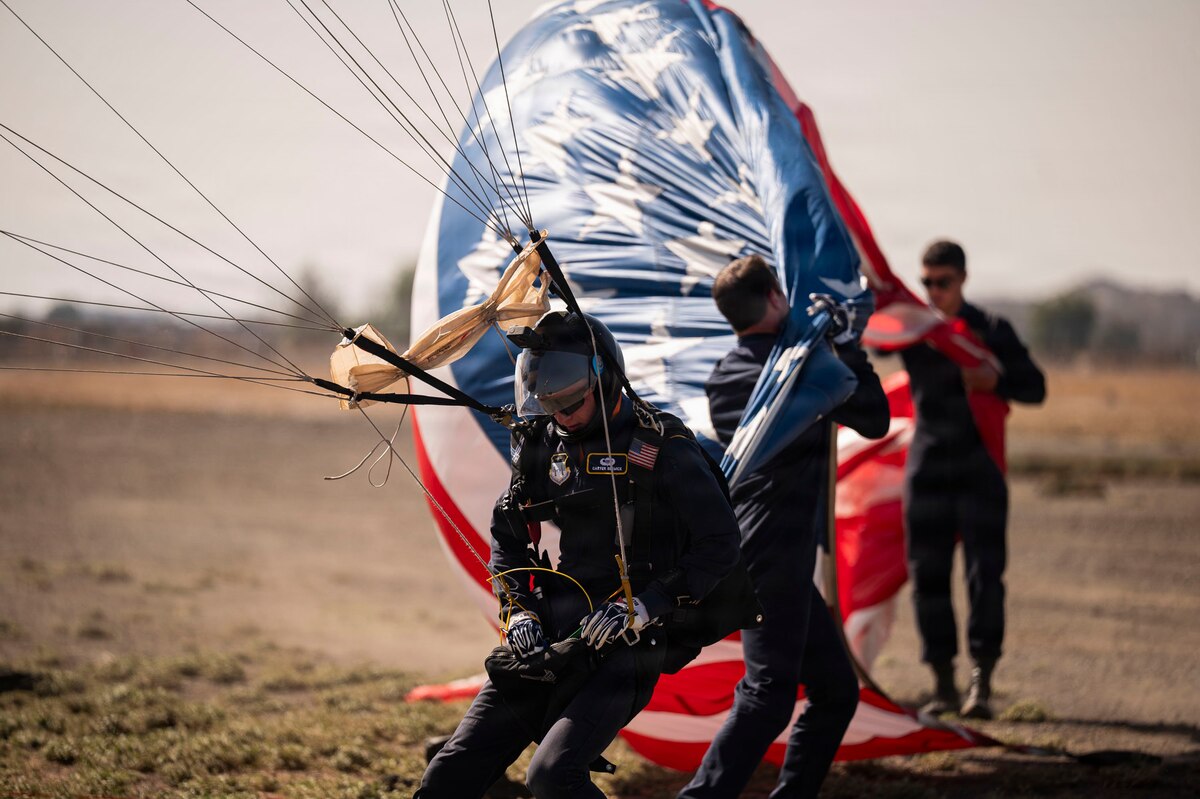 U.S. Air Force Academy Cadet Carter Beswick, a Wings of Blue parachutist, adjusts his equipment following a demonstration jump from a Texas Air National Guard HC-130 Combat King II during FIDAE in Santiago, Chile, April 11, 2026. Events like FIDAE provide a platform for the United States to demonstrate rapid global mobility capabilities and strengthen defense partnerships with Chile and other allied nations. (U.S. Air Force photo by Airman 1st Class Samantha Melecio)