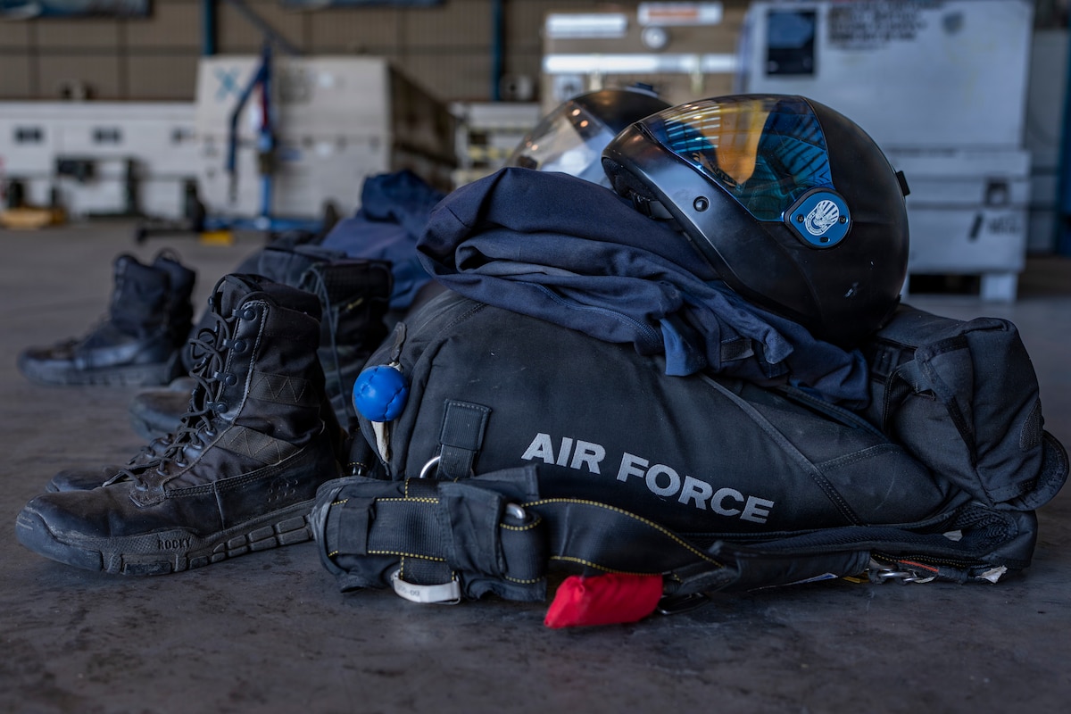 U.S. Air Force Academy Wings of Blue parachutist gear sits in a hangar prior to a demonstration jump during Feria Internacional del Aire y del Espacio (FIDAE) 2026 in Santiago, Chile, April 11, 2026. The Wings of Blue Demonstration team represents the next generation of Air Force leaders, showcasing discipline and skill while strengthening international partnerships through engagement at premier events like FIDAE. (U.S. Air Force photo by Andrea Jenkins)