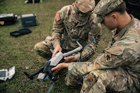 Two Oklahoma National Guardsmen replace a drone’s battery during Exercise Lightning Strike at Camp Gruber Training Center, Oklahoma, April 15, 2026.