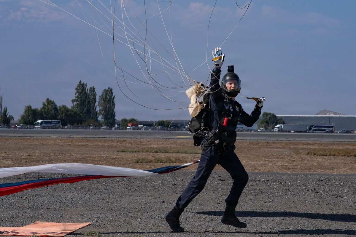 U.S. Air Force Lt. Col. Tripp Johnson, Wings of Blue commander, lands following a parachute demonstration during Feria Internacional del Aire y del Espacio (FIDAE) in Santiago, Chile, April 11, 2026. The demonstration underscores the professionalism and precision of U.S. Air Force personnel while supporting international engagement through aerial demonstration and outreach. (U.S. Air Force photo by Andrea Jenkins)