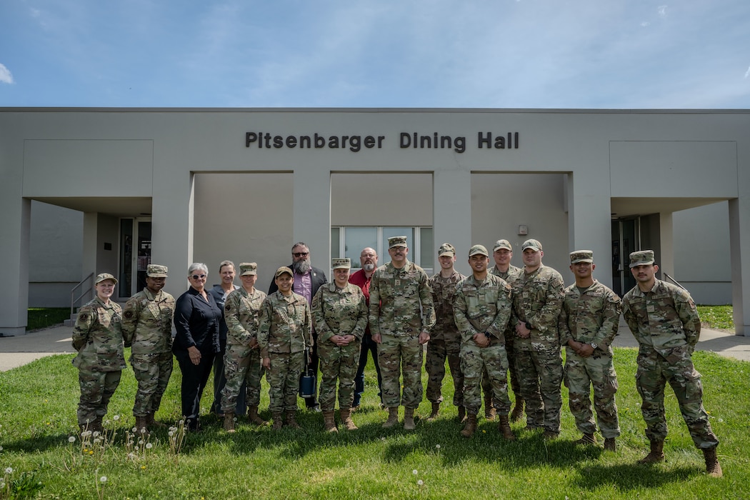 Senior Air Force leaders stand with a group of Airmen outside the Pitsenbarger Dining Hall at Wright-Patterson Air Force Base
