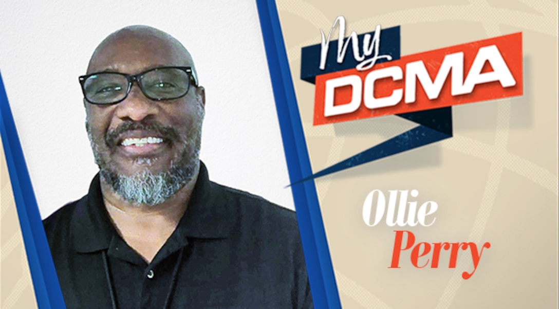 Smiling man with a beard and black glasses wears a black shirt