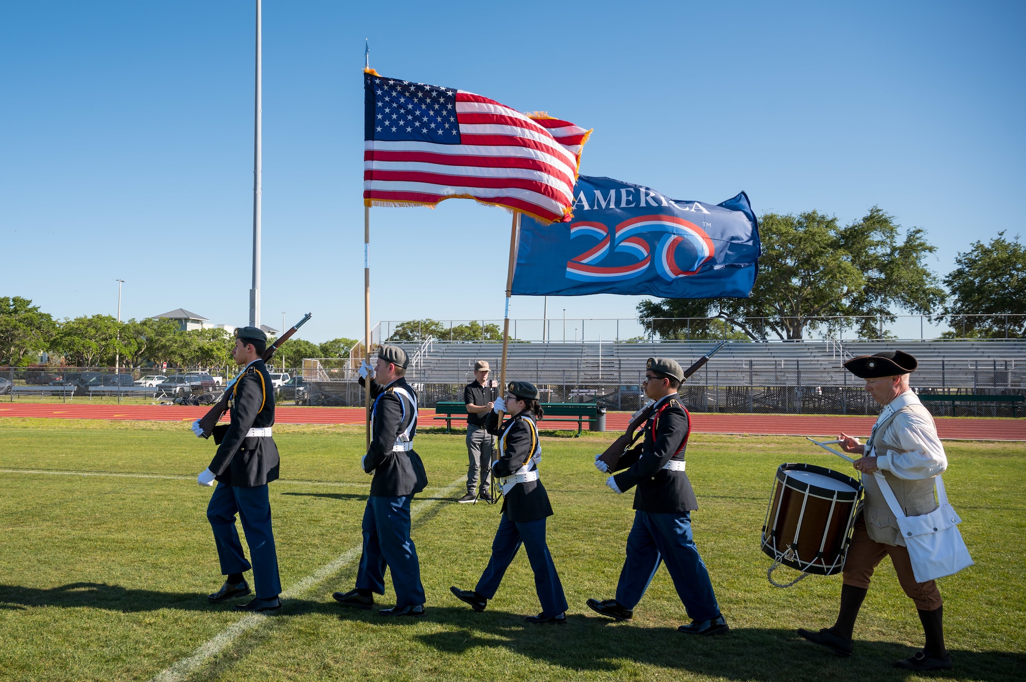 Participants march and perform during the opening ceremony at the 2026 Enlistment Ceremony of the Space Coast at Viera High School in Melbourne, Fla., April 17, 2026. More than 250 enlistees committed to serve in the U.S. military, which brought together families, educators and community leaders from across Brevard County. (U.S. Space Force photo by Gwendolyn Kurzen).