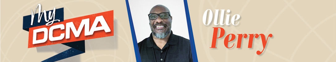 Smiling man with a beard wears glasses and a black shirt