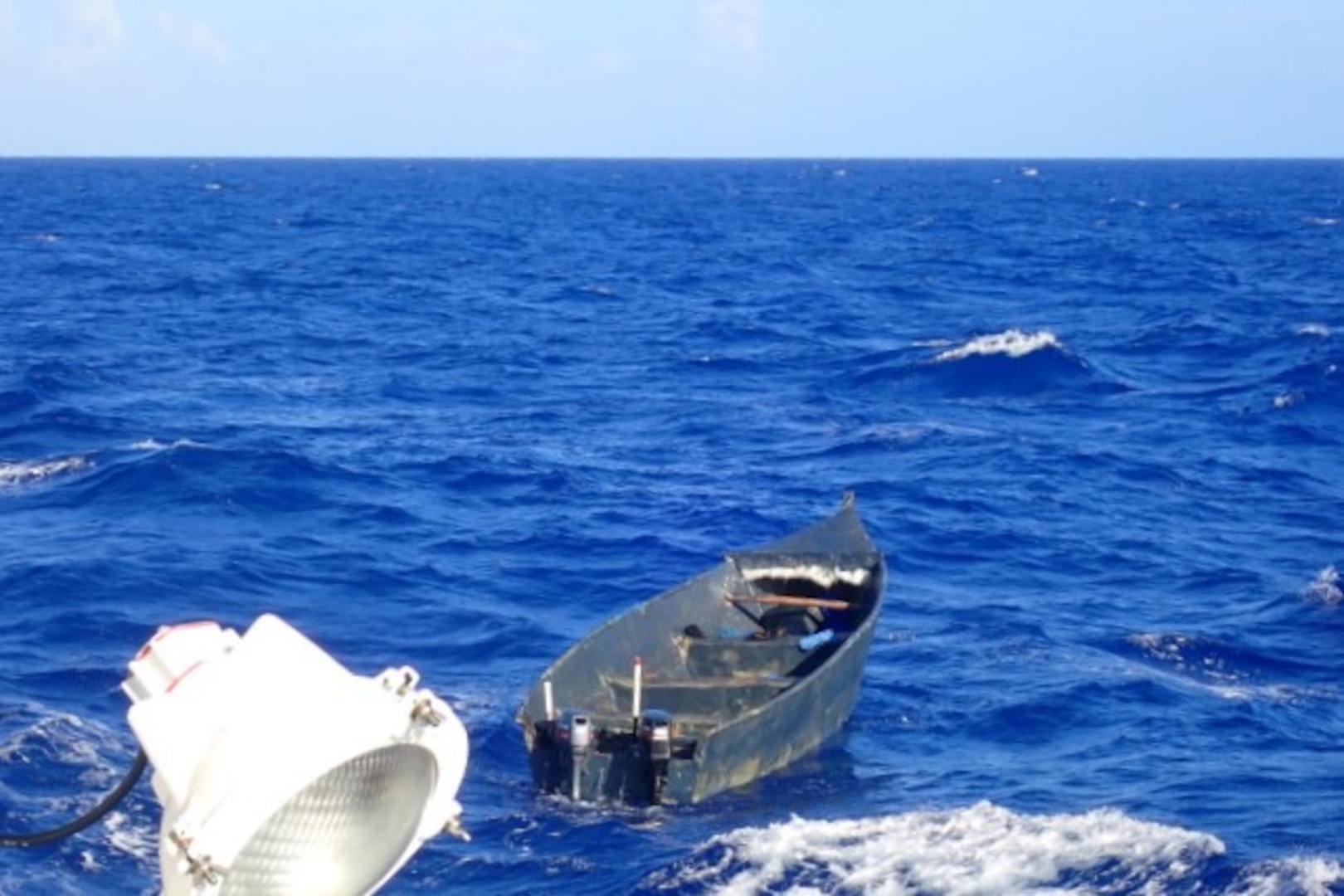 A Coast Guard Cutter Joseph Tezanos crewmember photographs an empty yola in Mona Passage waters off Puerto Rico April 20, 2026. Cutter Joseph Tezanos and a U.S. Customs and Border Protection aircrew interdicted 22 migrants aboard a makeshift vessel off Aguadilla, Puerto Rico, April 19, 2026.  Following the interdiction, cutter Joseph Tezanos rendezvoused with two Dominican Republic Navy patrol vessels off Punta Cana, Dominican Republic and repatriated 21 of the migrants in the group. (U.S. Coast Guard photo)