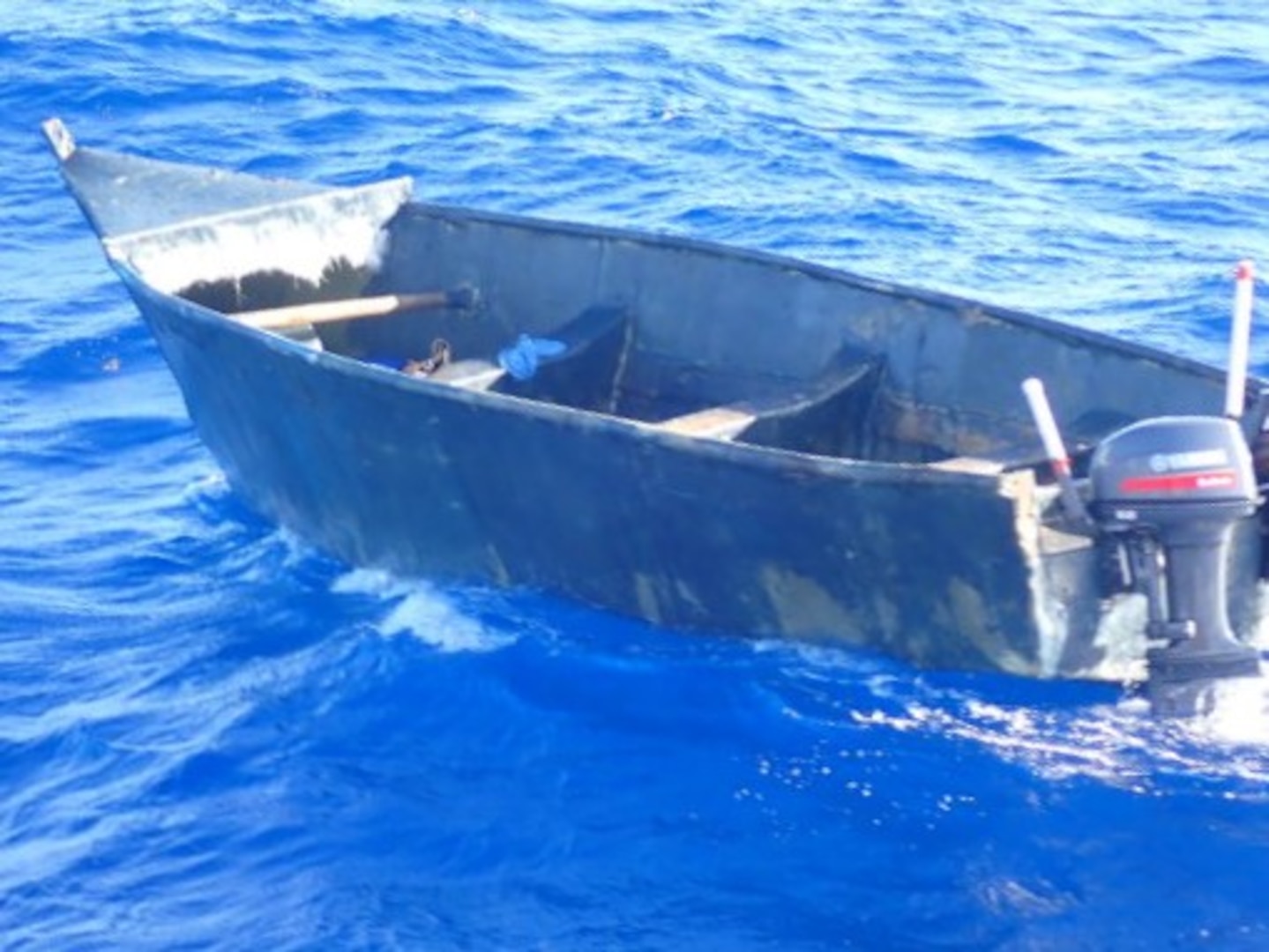 A Coast Guard Cutter Joseph Tezanos crewmember photographs an empty yola in Mona Passage waters off Puerto Rico April 20, 2026. Cutter Joseph Tezanos and a U.S. Customs and Border Protection aircrew interdicted 22 migrants aboard a makeshift vessel off Aguadilla, Puerto Rico, April 19, 2026.  Following the interdiction, cutter Joseph Tezanos rendezvoused with two Dominican Republic Navy patrol vessels off Punta Cana, Dominican Republic and repatriated 21 of the migrants in the group. (U.S. Coast Guard photo)