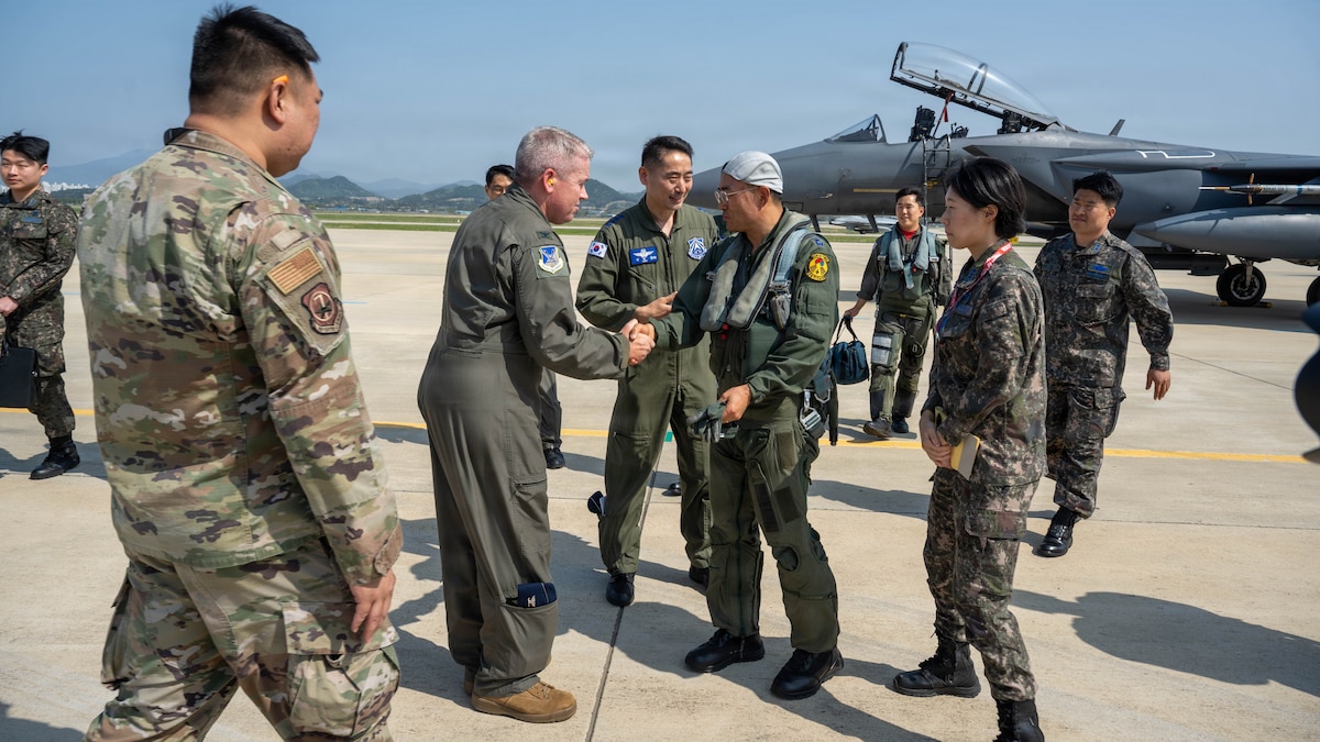 U.S. Air Force Col. Brad Dvorak, left, 31st Air Expeditionary Wing commander, greets South Korea air force Lt. Gen. Jun Sun Cha, right, South Korea air force Operations Command commander, during exercise Freedom Flag 26-1.