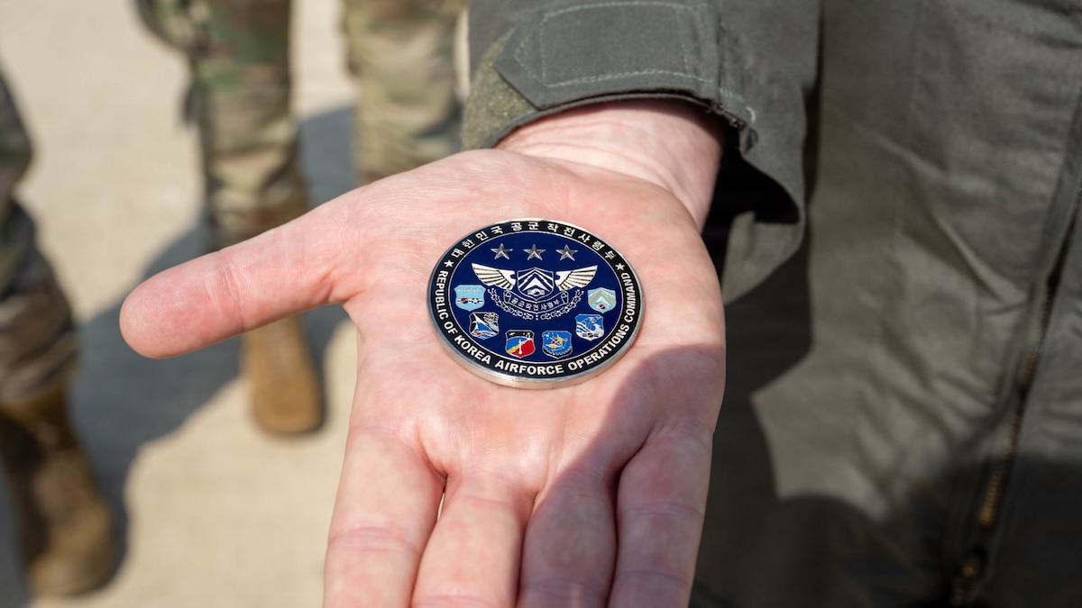 U.S. Air Force Col. Brad Dvorak, 31st Air Expeditionary Wing commander presents a coin he received from South Korea air force Lt. Gen. Jun Sun Cha, South Korea air force Operations Command commander.