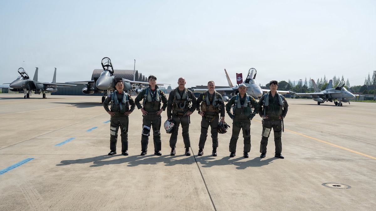 Pilots from the South Korea air force and the U.S. Marine Corps, pose for a photo with two South Korea F-15K Slam Eagles and two U.S. Marine F/A-18 Hornets in the background during exercise Freedom Flag 26-1 at Gwangju Air Base, South Korea.
