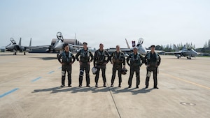 Pilots from the South Korea air force and the U.S. Marine Corps, pose for a photo with two South Korea F-15K Slam Eagles and two U.S. Marine F/A-18 Hornets in the background during exercise Freedom Flag 26-1 at Gwangju Air Base, South Korea.