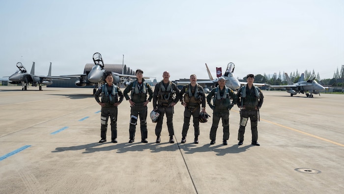 Pilots from the South Korea air force and the U.S. Marine Corps, pose for a photo with two South Korea F-15K Slam Eagles and two U.S. Marine F/A-18 Hornets in the background during exercise Freedom Flag 26-1 at Gwangju Air Base, South Korea.