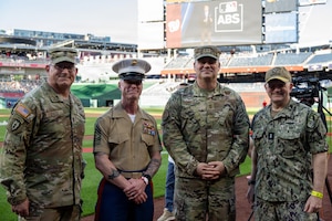 Four service joint leaders take group photo on feild.