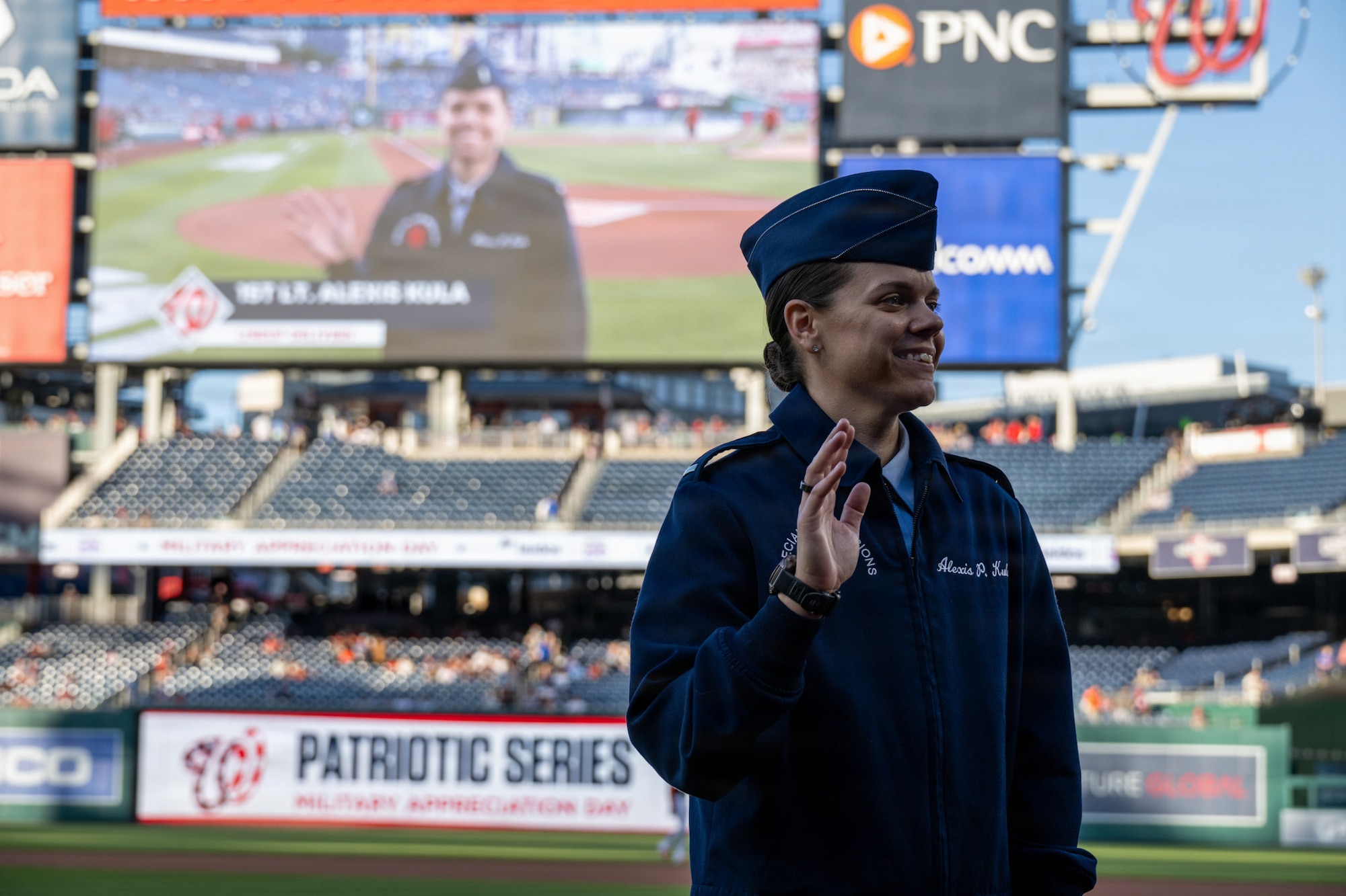 Woman is shown on big screen.