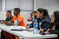Public relations and communications specialists with several of Panama’s safety and security agencies take notes during a public affairs-focused subject matter expert exchange in Panama City, Feb. 24, 2026. Over the three-day exchange, public affairs professionals with the Missouri Guard and its partner nation, Panama, discussed current practices, ideas for process improvements and insights on communication strategy. (U.S. Air National Guard photo by Master Sgt. Stephanie Mundwiller)