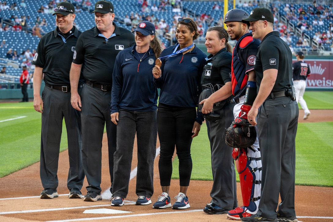 people stand on a baseball field.