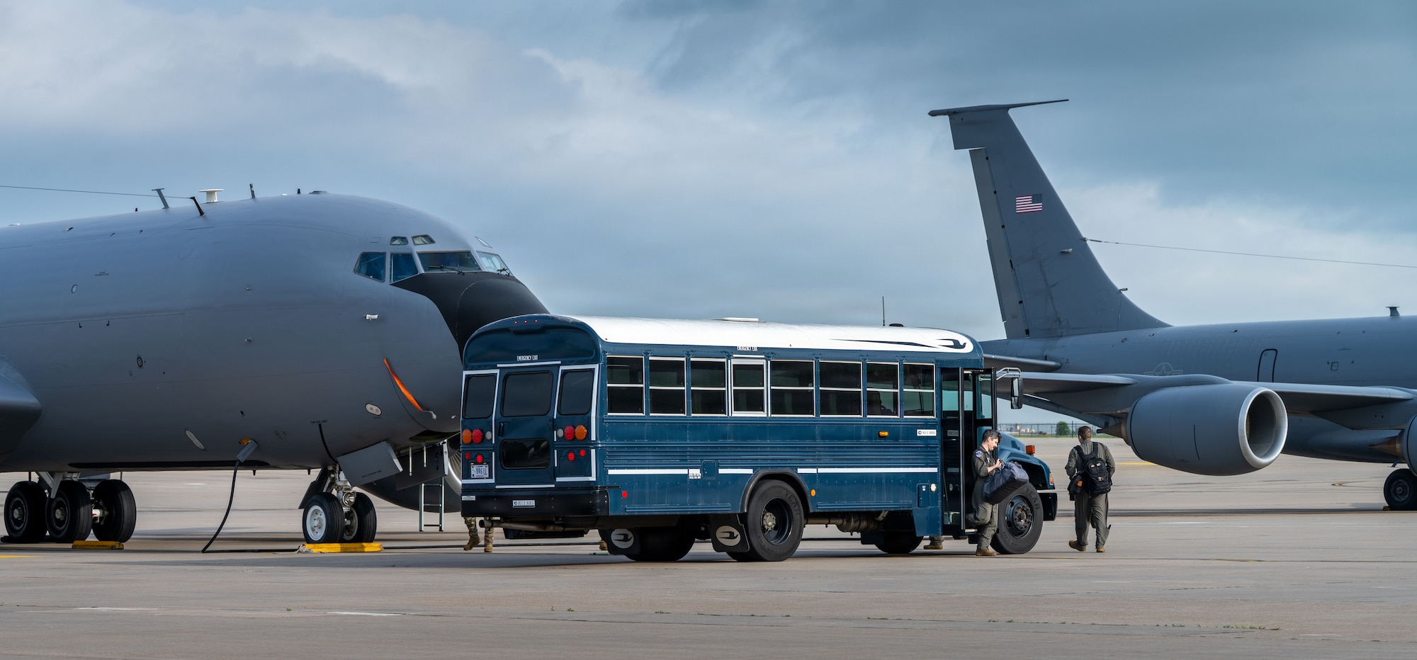 Team McConnell aircrew members step off a ground transportation bus in preparation of a weather evacuation on the flightline at McConnell Air Force Base, Kansas, April 17, 2026. In response to forecasted severe weather, maintenance and aircrew teams relocated aircraft to minimize potential damage. These efforts highlight the wing’s commitment to protecting resources and maintaining mission readiness in dynamic conditions. (U.S. Air Force photo by Senior Airman Paula Arce)