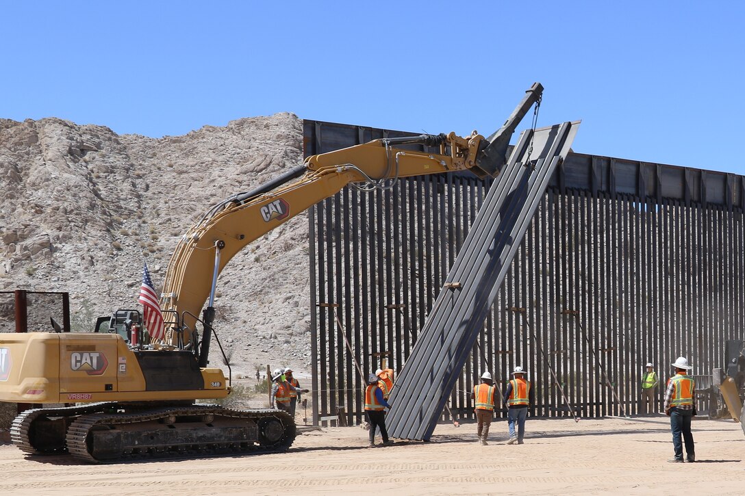 U.S. Army Corps of Engineers South Pacific Border Task Force installs the final border barrier panel at the Barry M. Goldwater Range, or BMGR-1, project site April 15 near Yuma, Arizona. USACE is replacing permanent border barriers along the southern border of the U.S. at the direction of the U.S. Army by the Secretary of War, in response to the presidential national emergency declaration dated Jan. 20, 2025, authorizing the use of Section 2803 of Title 10, U.S. Code.