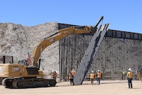 U.S. Army Corps of Engineers South Pacific Border Task Force installs the final border barrier panel at the Barry M. Goldwater Range, or BMGR-1, project site April 15 near Yuma, Arizona. USACE is replacing permanent border barriers along the southern border of the U.S. at the direction of the U.S. Army by the Secretary of War, in response to the presidential national emergency declaration dated Jan. 20, 2025, authorizing the use of Section 2803 of Title 10, U.S. Code.