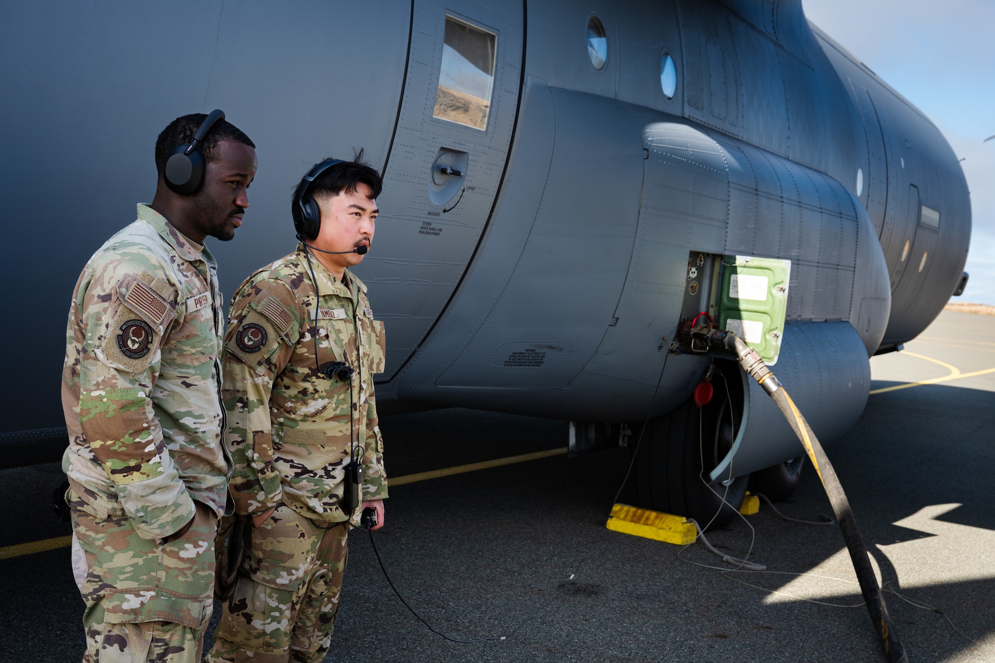 U.S. Air Force Senior Airman Jamaray Porter, 317th Aircraft Maintenance Squadron crew chief, left, and Senior Airman Christian Yambao, 317th AMXS assistant flying crew chief, monitor refueling operations for a Maximum Endurance Operation en route to Exercise Balikatan 2026 at Eareckson Air Station, Alaska, April 16, 2026. Balikatan is a longstanding annual exercise between the Armed Forces of the Philippines and U.S. military designed to strengthen our ironclad alliance, improve our capable combined force, and demonstrate our commitment to regional security and stability. (U.S. Air Force photo by Senior Airman Jade M. Caldwell)