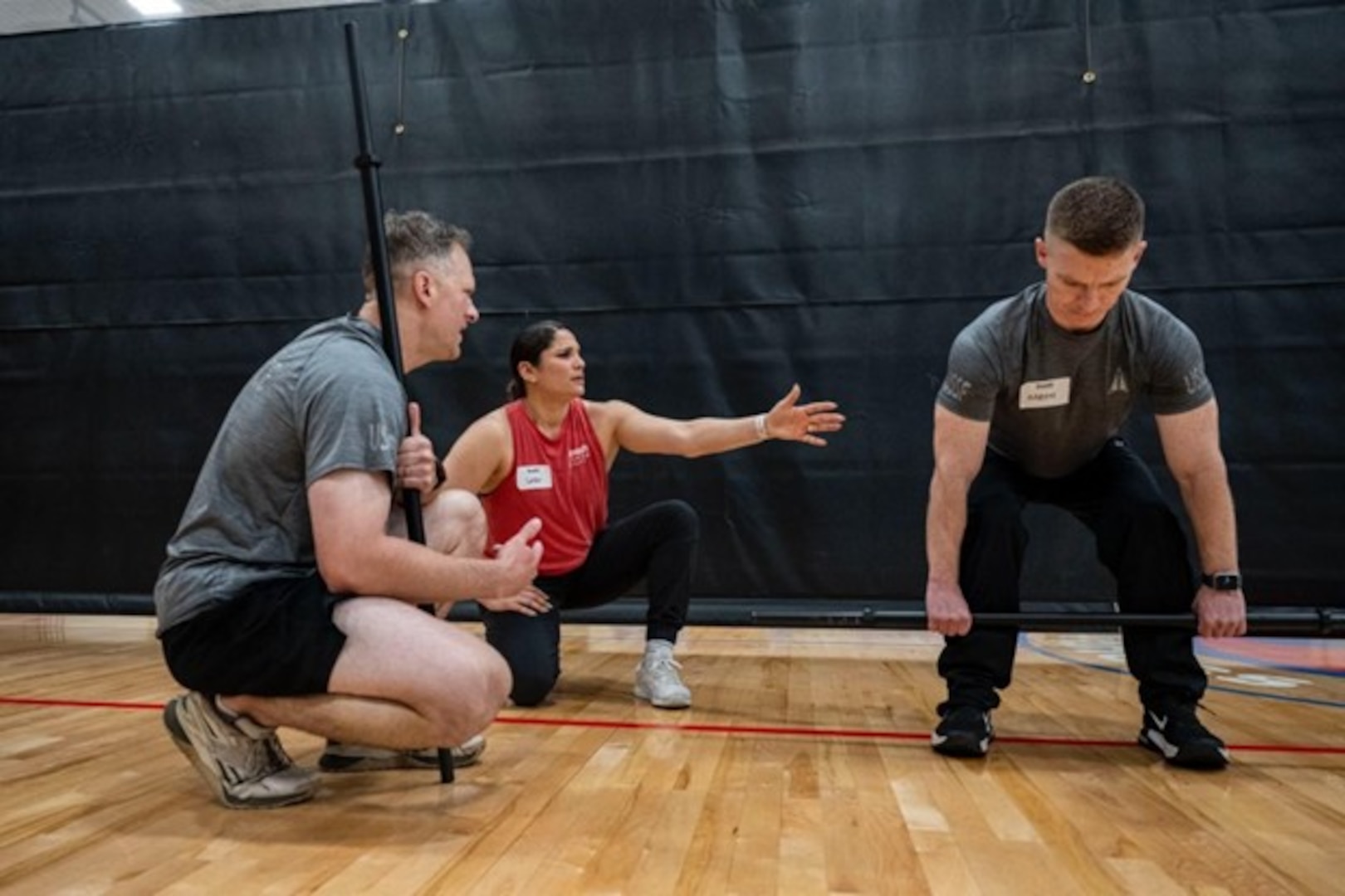 Gaby Serrati, CrossFit seminar trainer, instructs U.S. Space Force Guardians on proper deadlift form during a Space Force CrossFit training seminar at the Rambler Fitness Center, Joint Base San Antonio-Randolph, April 3, 2026. Guardians rehearsed each lift multiple times to build muscle memory and confidence.