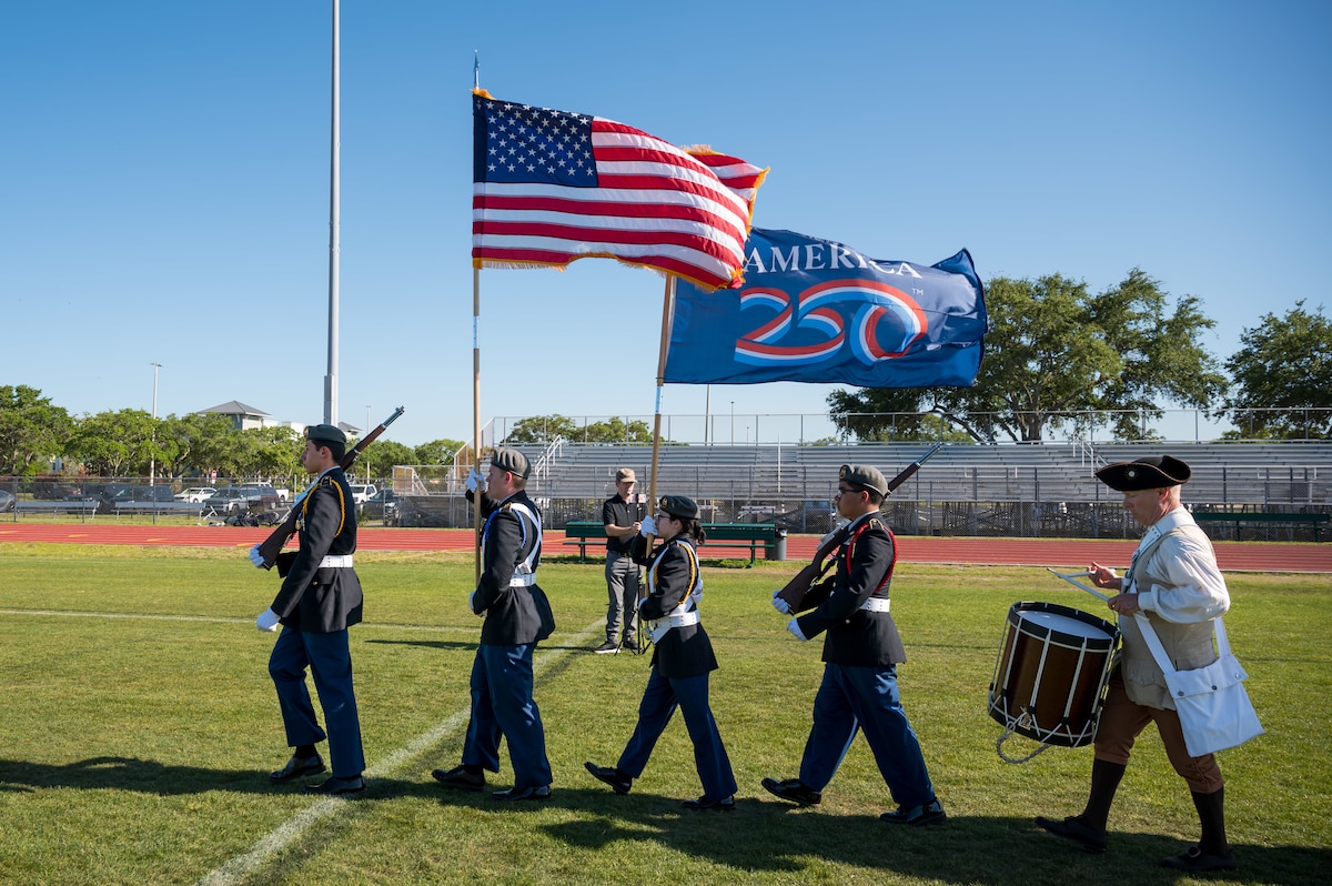 Participants march and perform during the opening ceremony at the 2026 Enlistment Ceremony of the Space Coast at Viera High School in Melbourne, Fla., April 17, 2026. More than 250 enlistees committed to serve in the U.S. military, which brought together families, educators and community leaders from across Brevard County. (U.S. Space Force photo by Gwendolyn Kurzen).