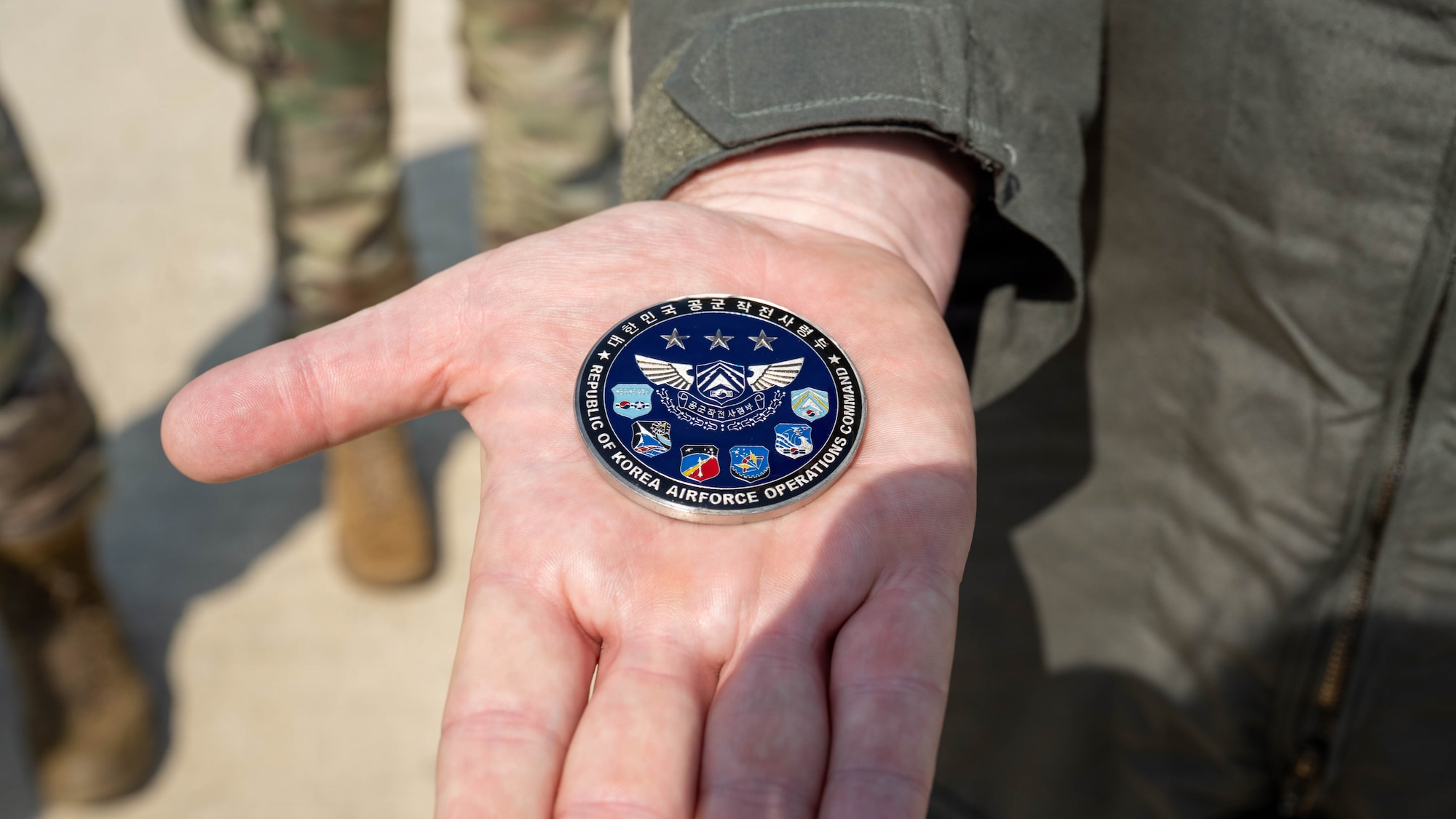 U.S. Air Force Col. Brad Dvorak, 31st Air Expeditionary Wing commander presents a coin he received from South Korea air force Lt. Gen. Jun Sun Cha, South Korea air force Operations Command commander.