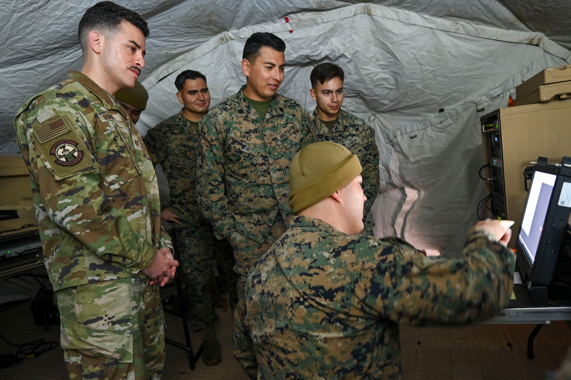 A group looks at a computer.
