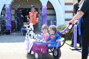 Children ride in a wagon.
