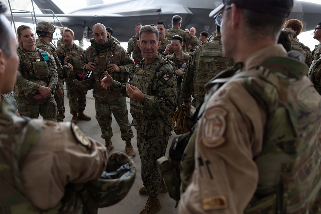 U.S. Navy Admiral Brad Cooper, commander of U.S. Central Command, engages with troops during an awards presentation at a base in the Middle East. Cooper visited troops to answer questions and recognize their achievements in their continued efforts. (U.S. Navy photo by Senior Chief Mass Communication Specialist Amanda Dunford)