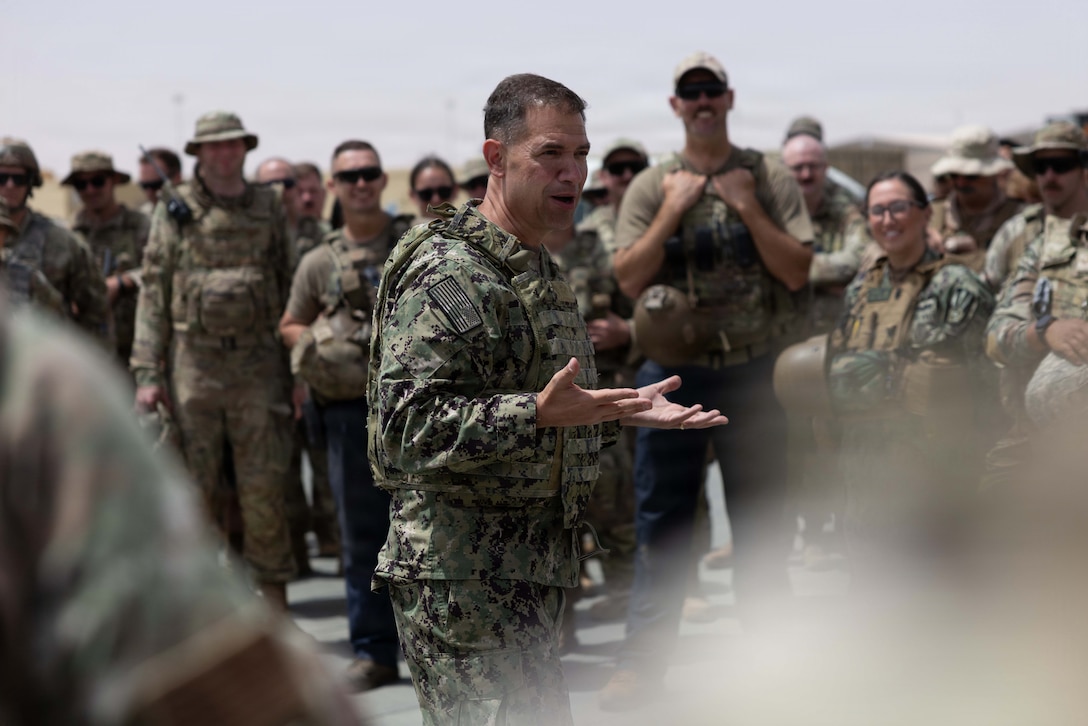 U.S. Navy Admiral Brad Cooper, commander of U.S. Central Command, engages with troops during an awards presentation at a base in the Middle East. Cooper visited troops to answer questions and recognize their achievements in their continued efforts. (U.S. Navy photo by Senior Chief Mass Communication Specialist Amanda Dunford)