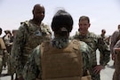 U.S. Navy Admiral Brad Cooper, commander of U.S. Central Command, and U.S. Navy Fleet Master Chief Lateef N. Compton, senior enlisted leader of U.S. Central Command, speak with a U.S. Navy Sailor during a troop engagement at a base in the Middle East. Cooper and Compton visited troops to answer questions and recognize their achievements in their continued efforts. (U.S. Navy photo by Senior Chief Mass Communication Specialist Amanda Dunford)