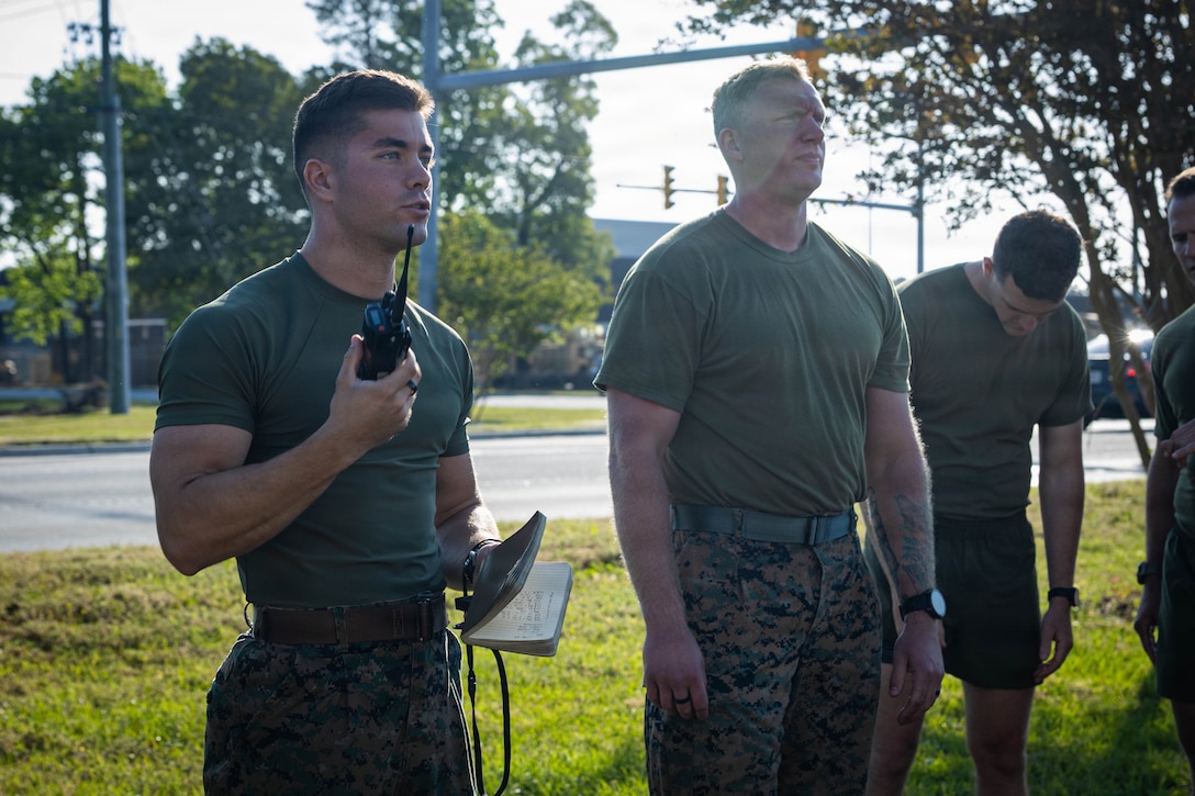 U.S. Marine Corps 1st Lt. Ethan Bright, left, Human Performance Director, and U.S. Navy Hospital Corpsman 1st Stephen Bubenko, center right, staff noncommissioned officer in charge, both with the 2nd Marine Logistics Group Human Performance Center, instruct Marines and Sailors during a Fittest of the MLG competition hosted by the 2nd MLG HPC at Marine Corps Base Camp Lejeune, North Carolina, April 17, 2026. Twice a year, teams from across 2nd MLG’s battalions compete for the title of “Fittest of the MLG” to promote physical fitness, camaraderie, and friendly competition. (U.S. Marine Corps photo by Lance Cpl. Isabella Ramos)