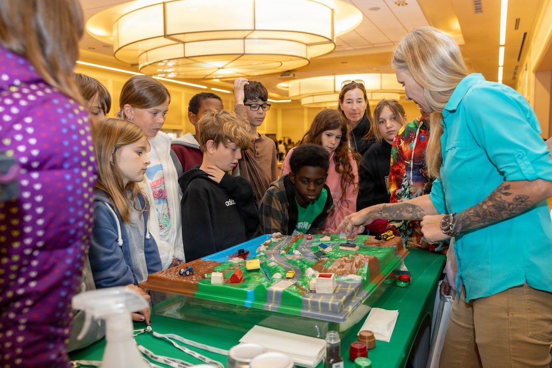 Jessica Anderson, an environmental protection specialist with the Camp Lejeune Environmental Management Division, teaches students from Bitz Intermediate School during an Earth Day event hosted by the EMD at Marston Pavilion on Marine Corps Base Camp Lejeune, North Carolina, April 20, 2026. The annual event celebrates Earth Day and educates students, service members and their families on protecting natural resources, preventing pollution and preserving wildlife. (U.S. Marine Corps photo by Lance Cpl. Erica S. Padgett)
