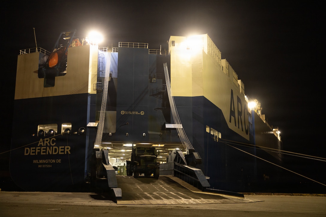 U.S. Marines alongside crew from the ARC DEFENDER offload medium tactical vehicle replacements during exercise Aurora as part of Sword 26 in Fiborgatagnen, Norway, April 16, 2026. Ground and logistical equipment assigned to Combat Logistics Battalion 24 was offloaded and transported in preparation for the exercise. U.S. Marines and Sailors with 2nd Marine Logistics Group are participating in Aurora as part of the larger Sword 26 series of linked multinational exercises. This participation directly supports NATO's Eastern Flank Deterrence Initiative concept, validates defense plans, builds a unified lethal force, and strengthens deterrence. (U.S. Marine Corps photo by Lance Cpl. Franco Lewis)