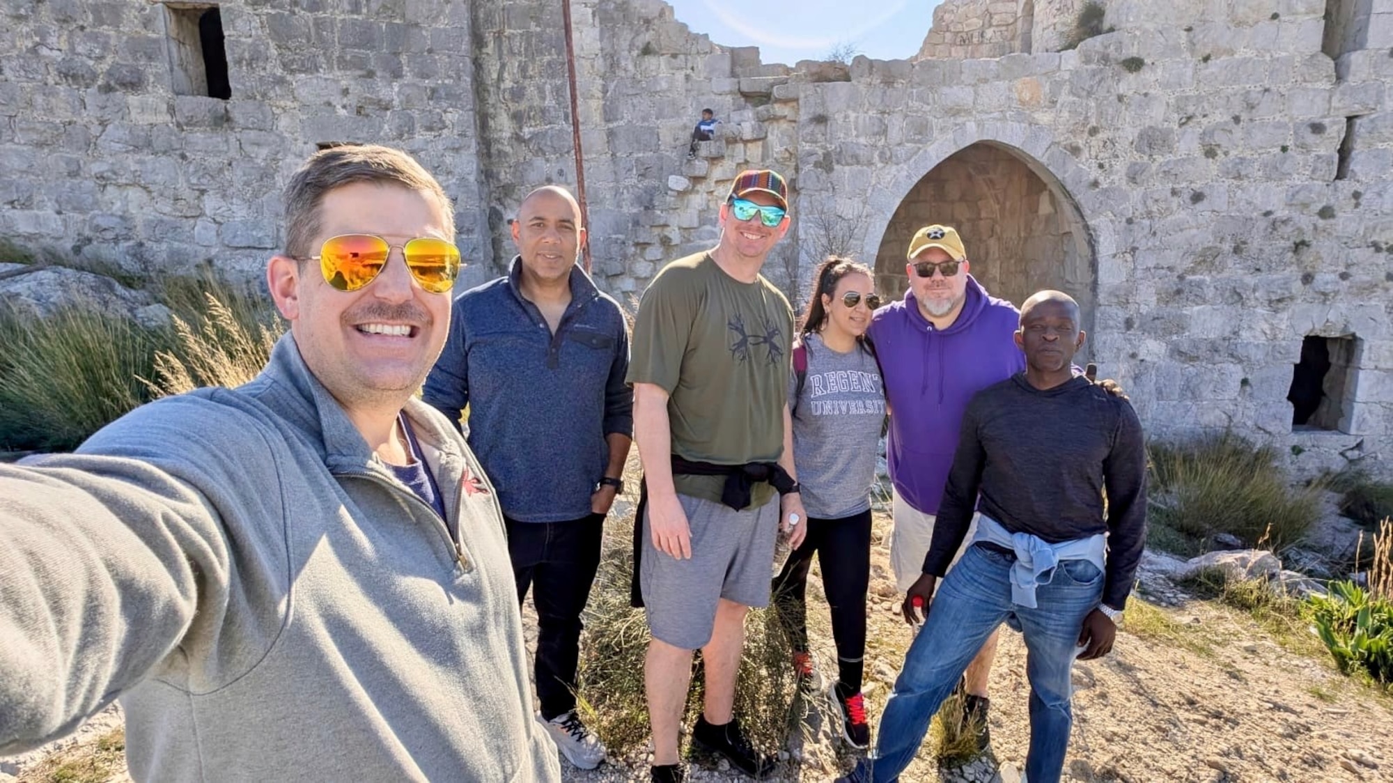 A group of people stand in front of a building.