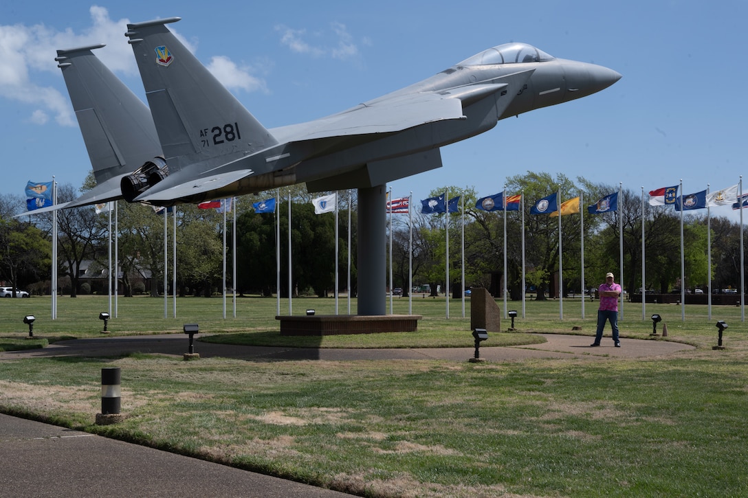 A man stands beside a F-15A Eagle.