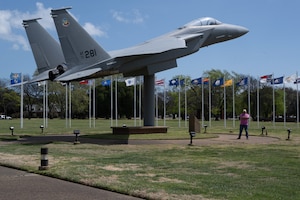 A man stands beside a F-15A Eagle.