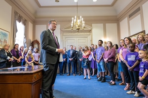 Delaware Gov. Matt Meyer speaks to a group of students, parents and faculty from across the state before signing a document proclaiming April as the Month of the Military Child in Dover, Delaware, April 16, 2026. The Month of the Military Child was established in 1986 to recognize the contributions and personal sacrifices children make during their parents’ service in the armed forces. (U.S. Air Force photo by Mauricio Campino)