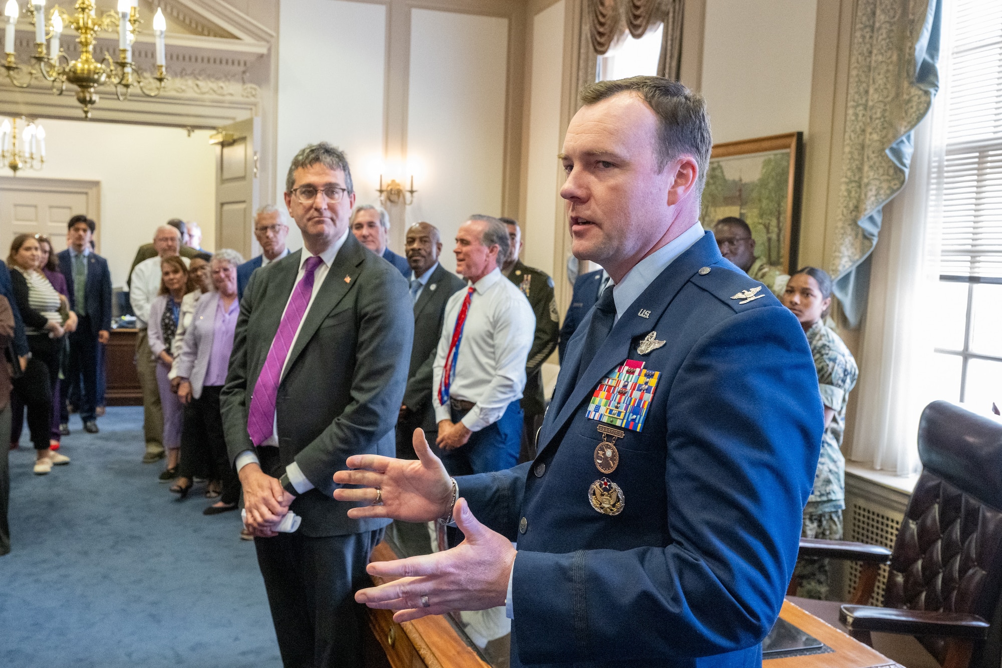 U.S. Air Force Col. Justin Longmire, 436th Airlift Wing deputy commander, speaks to a group of students, parents and faculty from various schools during the Month of the Military Child proclamation signing at Legislative Hall in Dover, Delaware, April 16, 2026. Longmire spoke about his family's personal experiences with transitions to several new schools throughout his military career. (U.S. Air Force photo by Mauricio Campino)