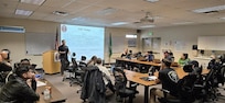 Maj. Jaymar Imperial, Operations Officer, 10th Civil Support Team gives a briefing during a multi-agency Radiation Response Workshop, April 3, 2026 at Camp Murray, Wash.