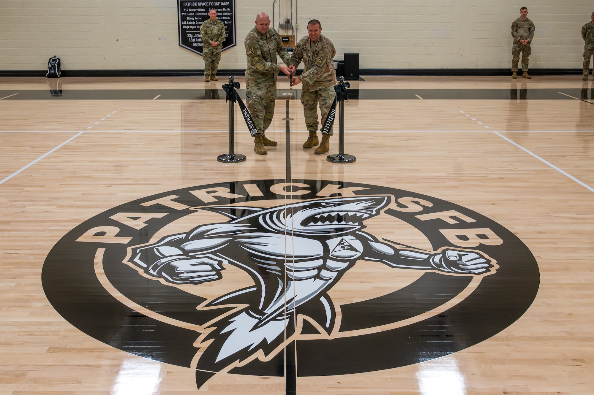 U.S. Space Force Col. Brian Chatman, Space Launch Delta 45 commander, cuts ribbon with U.S. Air Force Lt. Col. Ryan Peake, 45th Force Support Squadron commander, signifying grand opening of newly renovated Patrick Space Force Base fitness center basketball court, Florida, Feb. 6, 2026. (U.S. Space Force photo by Gwendolyn Kurzen).