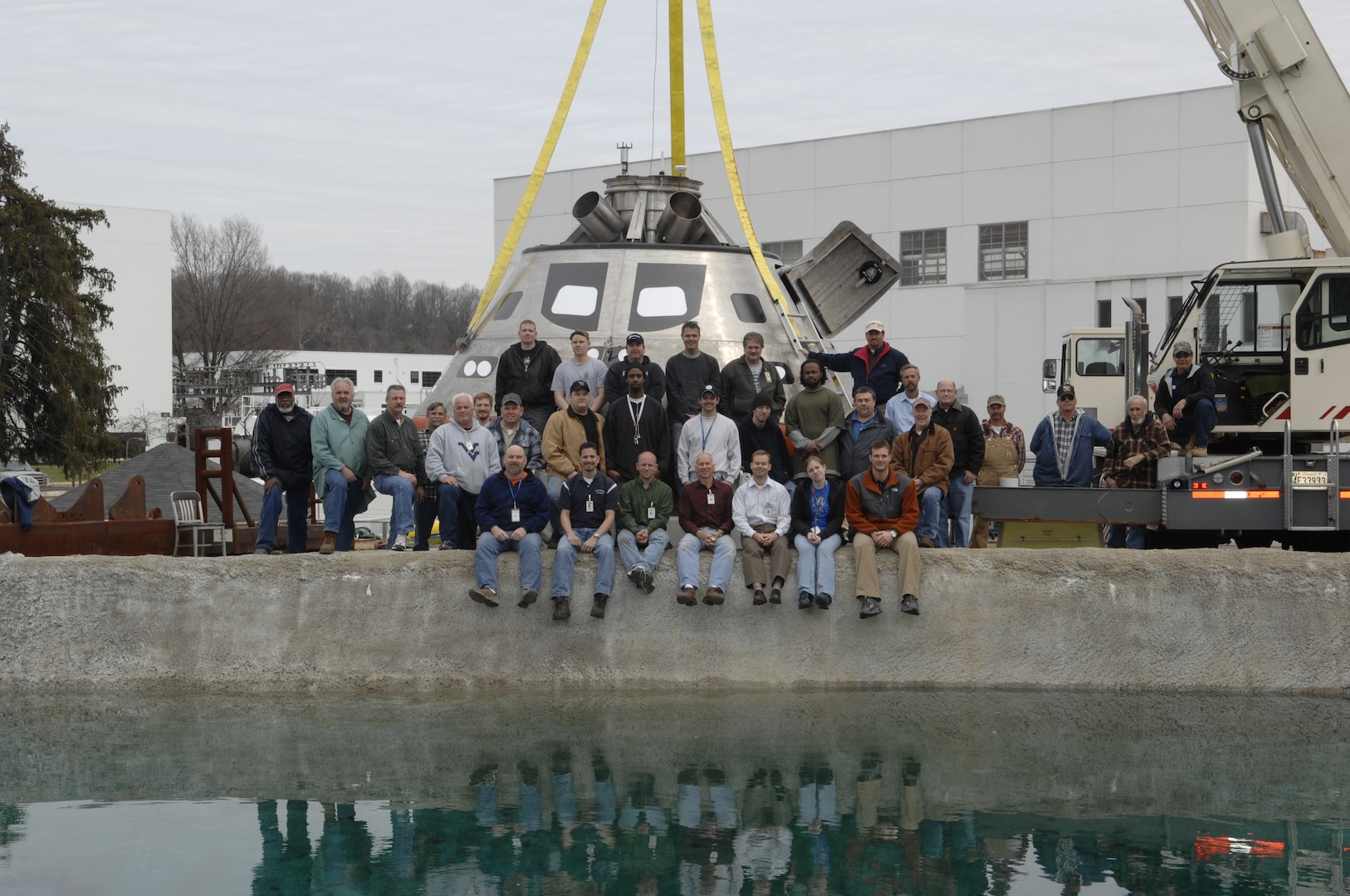 Naval Surface Warfare Center, Carderock Division engineers and technicians who supported the development and testing of NASA’s Orion capsule model pose at Carderock’s test pond